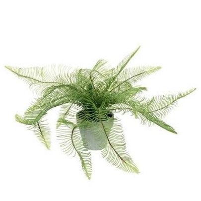 A faux feathered fern plant in a grey cement pot. 