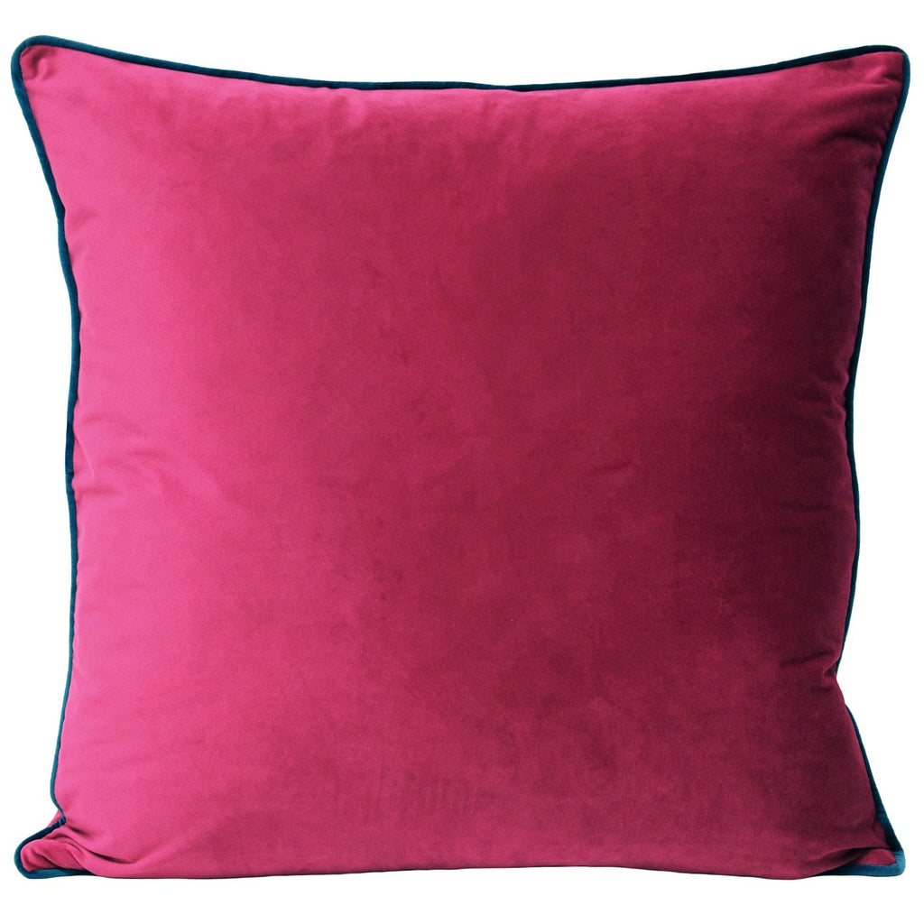 A large square cushion with a raspberry coloured velvet cover with teal piping. 