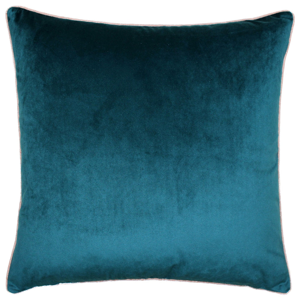 A large square cushion with a teal velvet cover edged with pale pink piping. 