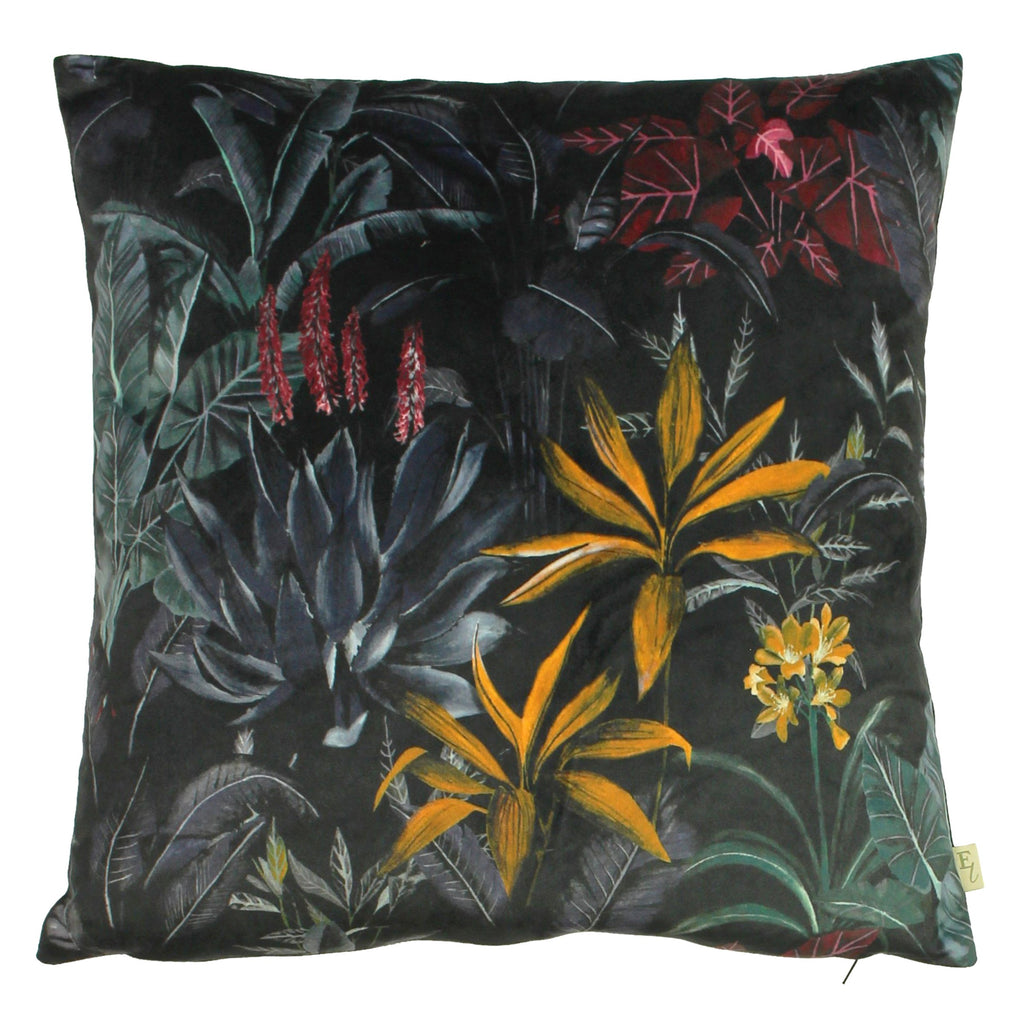 A large black velvet cushion decorated with tropical flora. 