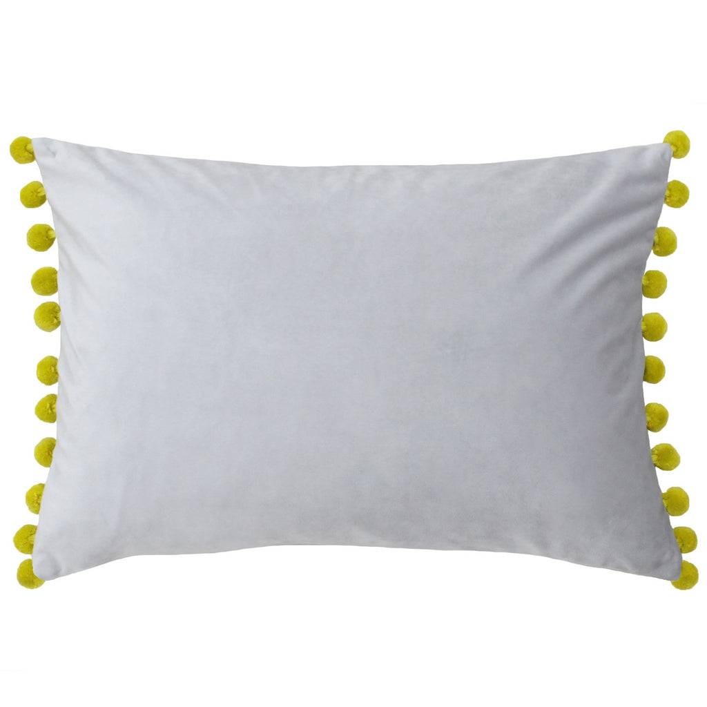 A rectangular cushion with a pale grey velvet cover and gold pompoms. 