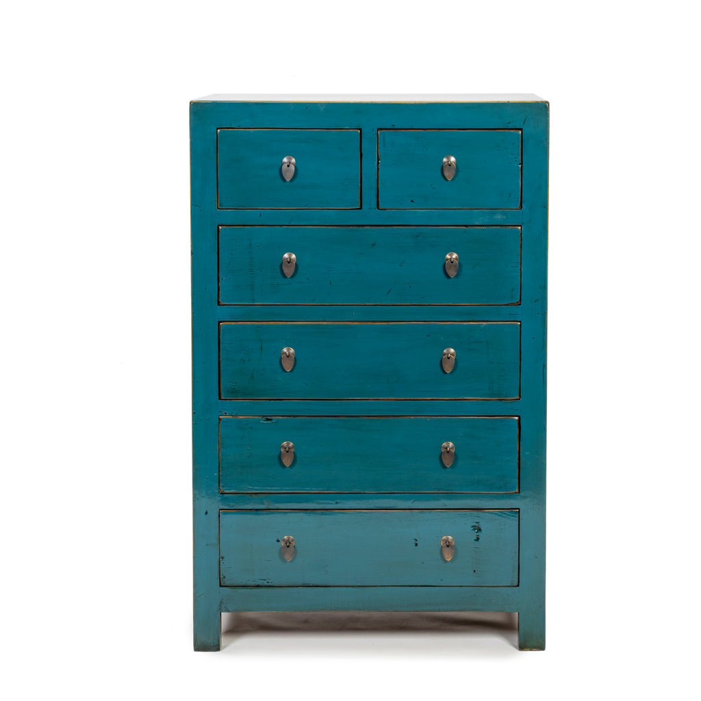 A tallboy chest of six drawers with brass handles and hand-finished in a slightly distressed blue lacquer. 