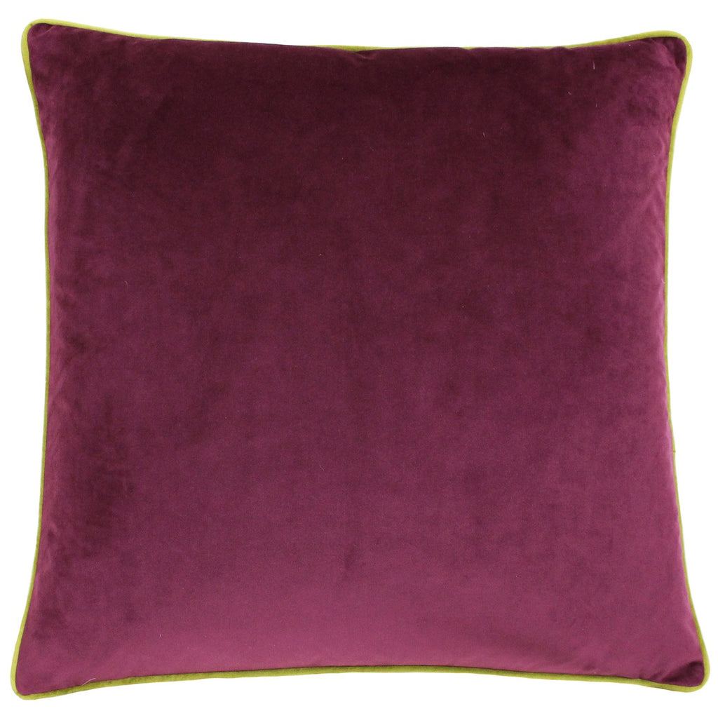 A large square pillow with a marroon velvet cover with moss piping.