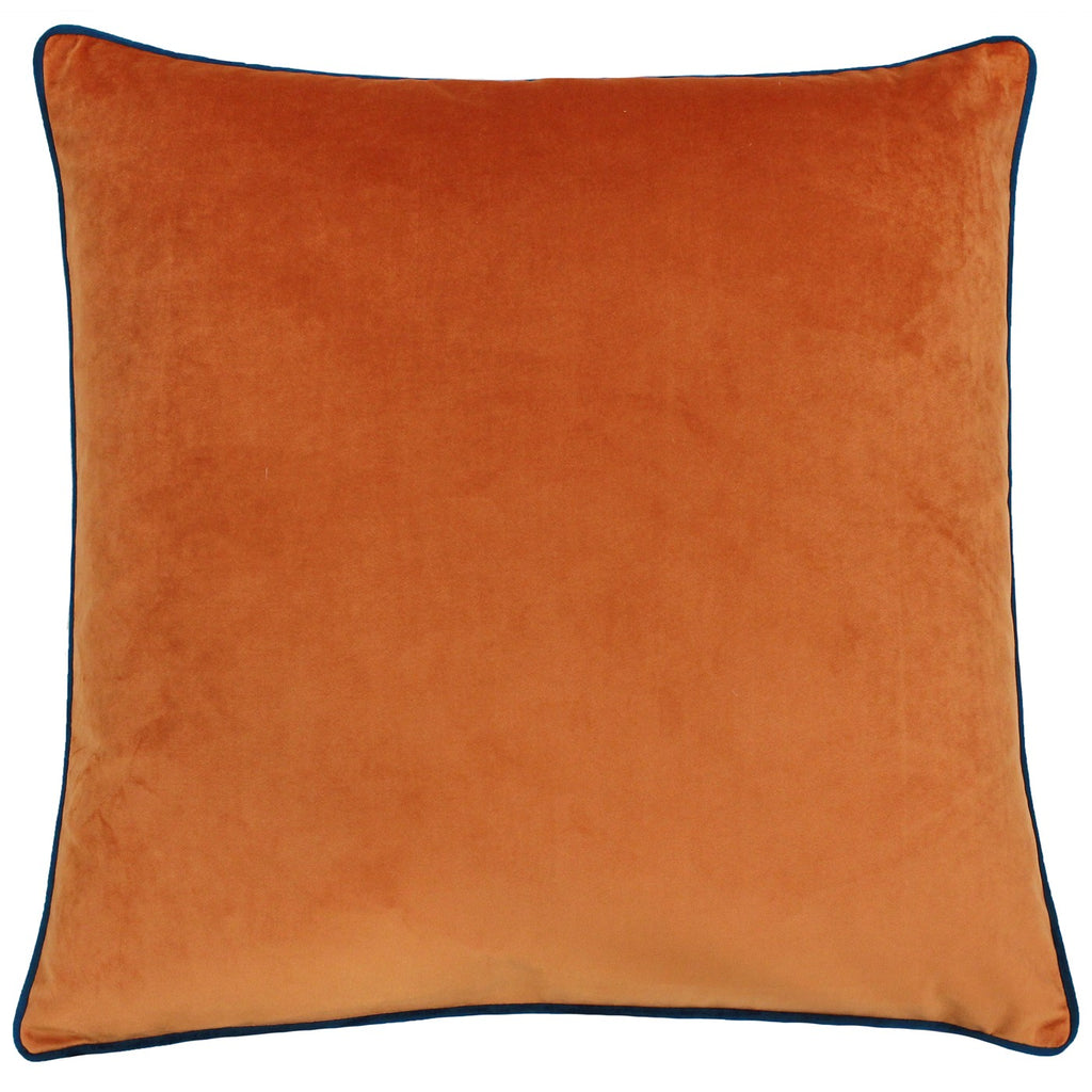A large square cushion with an orange and teal velvet cover. 